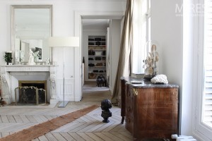 The herringbone floor, weathered and worn is the focal point of the room